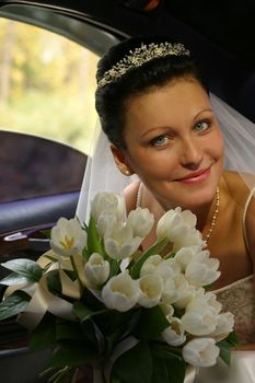 Portrait of the beautiful bride with a bouquet in hands