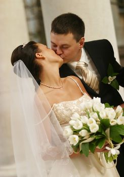 Beautiful the bride and the groom kiss