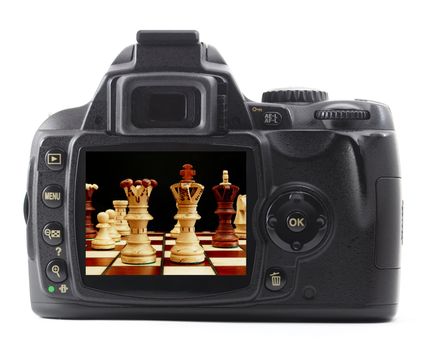 digital camera and chess pieces isolated on white background