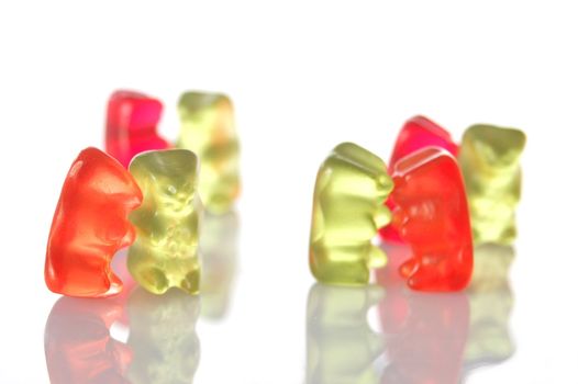 sweet gummy bears dancing on a party on white background