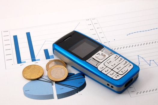 blue cell phone over business chart showing success