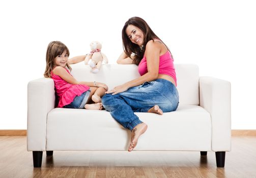 Beautiful pregnant mother with her daughter isolated on white
