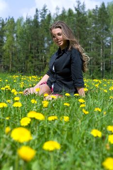  Young girl in short skirt on dandelion field