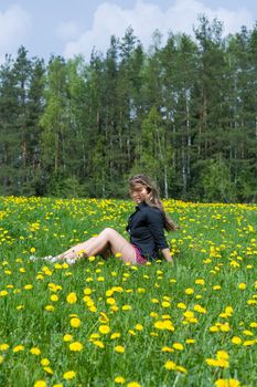  Young girl in short skirt on dandelion field