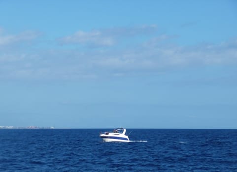 A small boat sailing within the sea.