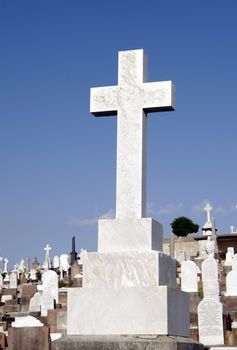 White Grave Stone Cross In Front Of Clear Blue Sky