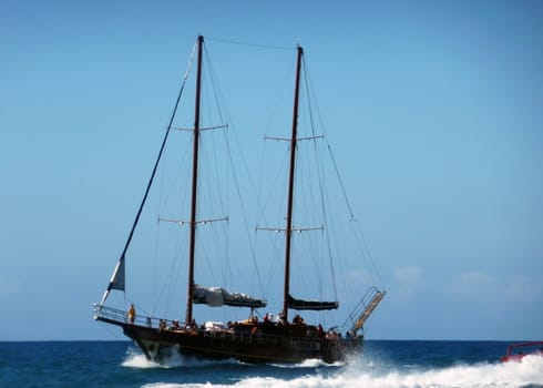 An old fashioned sailing ship in the sea.