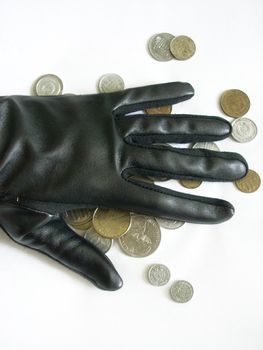 A hand in a leather glove with coins
