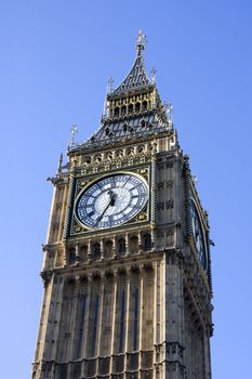 Big Ben clock tower, Westminster, London England against a blue sky