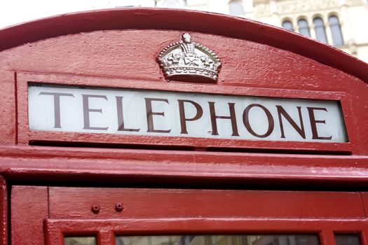 Close up of the telephone sign on a red london phone box