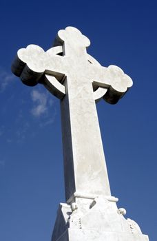 White Grave Stone Cross In Front Of Clear Blue Sky