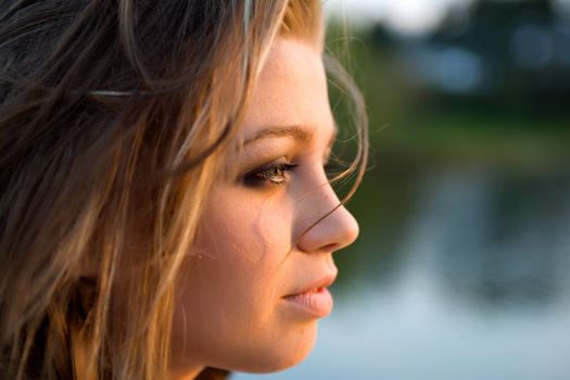 Portrait of young sexual girl on lake background