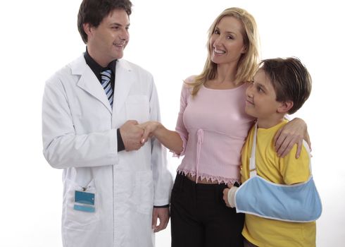 a mother and son thank the family doctor after treatment.