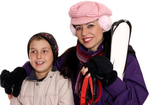 Mother and child clothed in ski gear ready for winter vacation or trip.