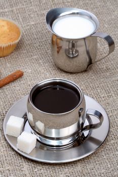 Cup of black coffee with muffin, milk and cinnamon, coffee series