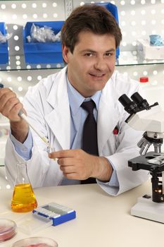 Friendly cheerful research scientist, chemist or medical technician in laboratory.