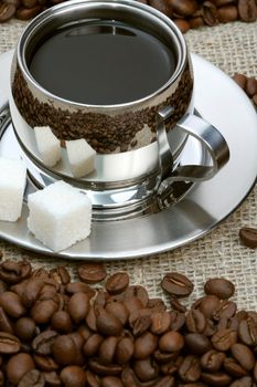 Cup of coffee with lump sugar and beans, coffee series