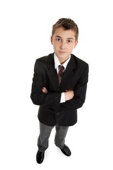 Serious boy standing with arms folded and looking up.  On a white background.  Shadow added under shoes.