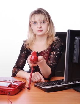 Sexy businesswoman  with phone in office in red gown