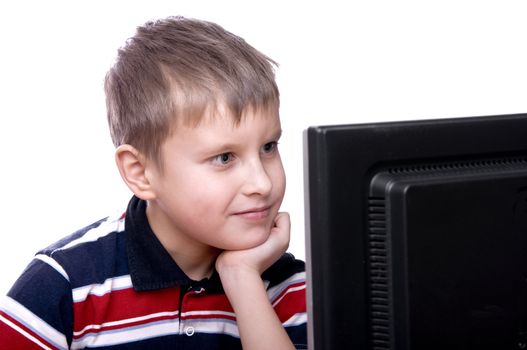 Portrait of a smiling young teenager working on computer isolated