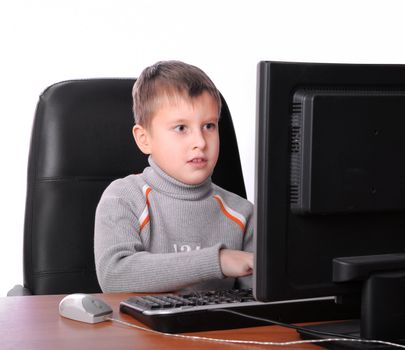 teenager sitting in armchair with computer monitor