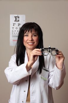 Optometrist or eye doctor holding trial frames used in vision eyesight checkup