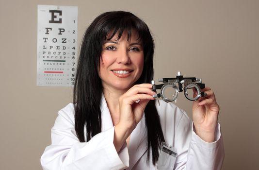 An eye doctor holding a pair of eye test trial  frames