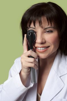 An eye doctor optometrist using opthalmoscope.