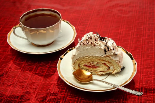 Cup of tea with the spoon and a slice of pie on red background, (look similar images in my portfolio)