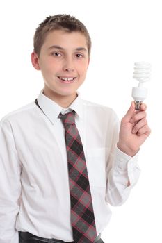 A smiling high school student holds an eco friendly fluorescent light bulb in his hand.