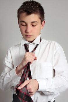 A school student getting dressed in uniform for school