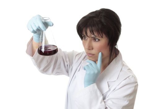Female scientist studying chemicals result in erlenmeyer flask.
