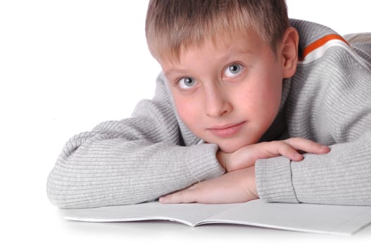 Young boy laying on the floor isolated over a white background