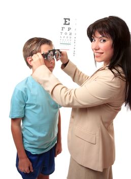 Smiling female optometrist stands with a child patient.