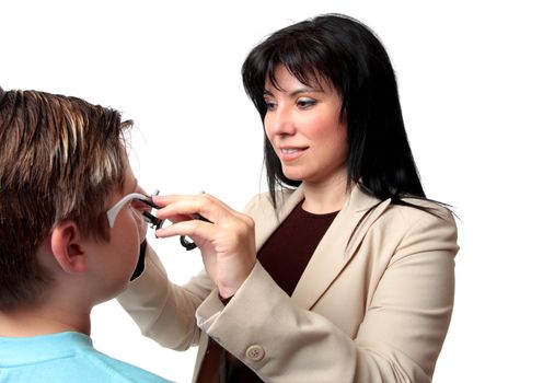 An optometrist puts trial frames on a patient