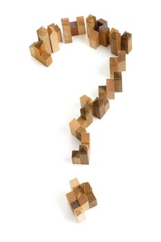 Wooden puzzle in the form of question mark on white background.