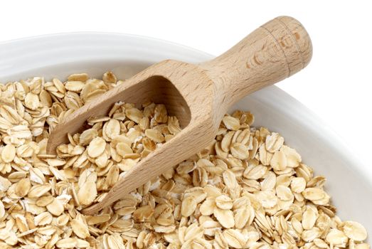 Seeds of oats with wooden spatula. Macro
