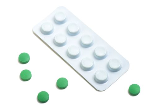 A macro shot of some green pills.