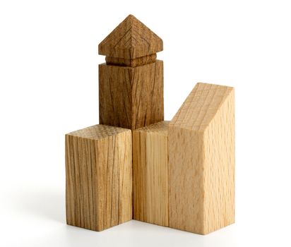 Detail of wooden puzzle in the form of buildings on white background. Macro.