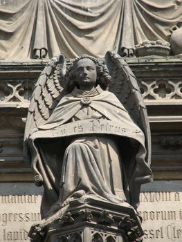 Stone angel at the main door portal of the cathedral at Cologne, Germany