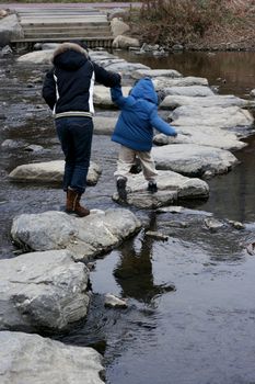 Mother and child Crossing the River Anyang in step stone.