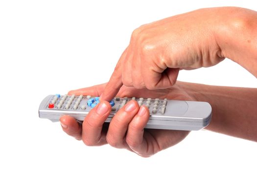 Woman's hand operating a remote control for a music center