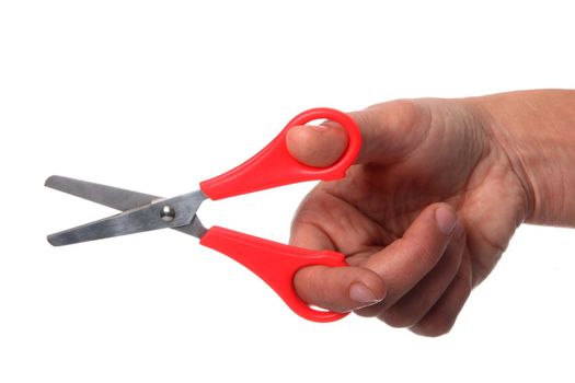 Woman's hand holding a pair of red handled scissors