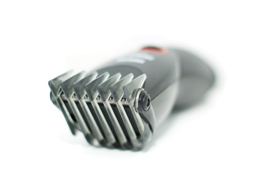 black electric hair hair clipper, extremely close-up, isolated on white