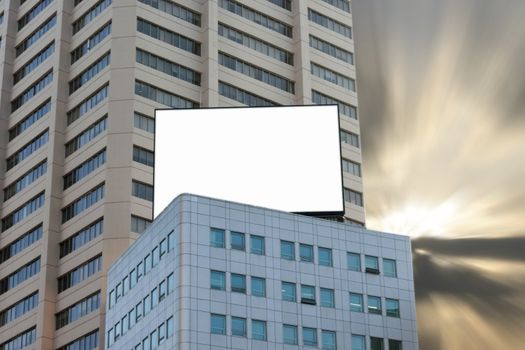 Blank Billboard on Top of Building with dramatic dusk background