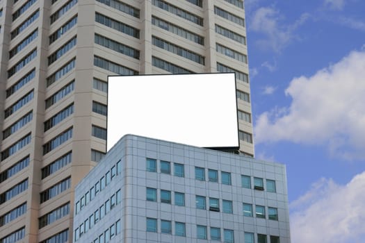 Blank Billboard on top of a building in a Blue sky