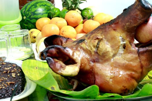 Lechon - a filipino delicacy during festivities and holiday seasons with fruits and rice cakes.