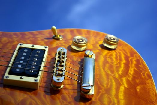 
A pillow maple guitar body against a blue sky