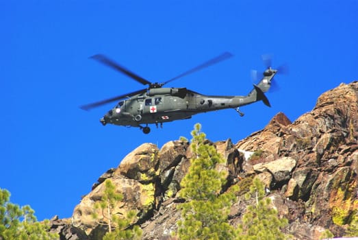 Air rescue by helicopter in the mountains at high altitude