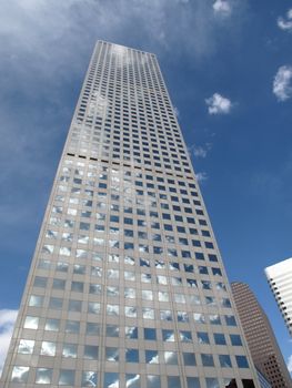 Modern Denver office building rises into a bright blue sky